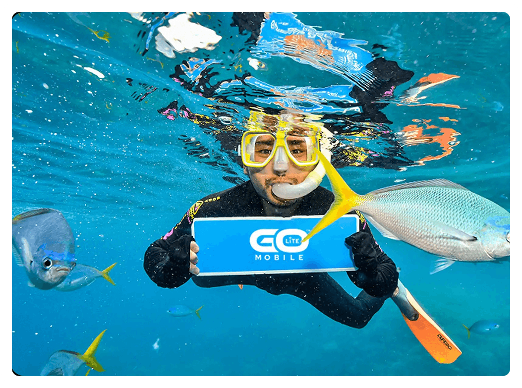 Scuba diver holding Go Mobile device underwater