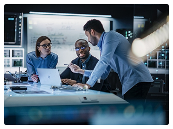 Analysts reviewing digital dashboards and metrics in high-tech control room