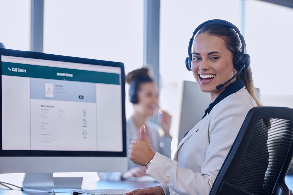 Professional woman wearing headset at workstation