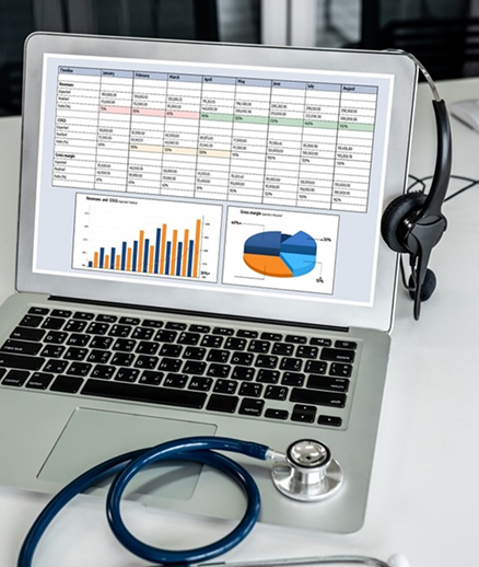 ZoikoNex Revenue Intelligence dashboard on laptop with stethoscope