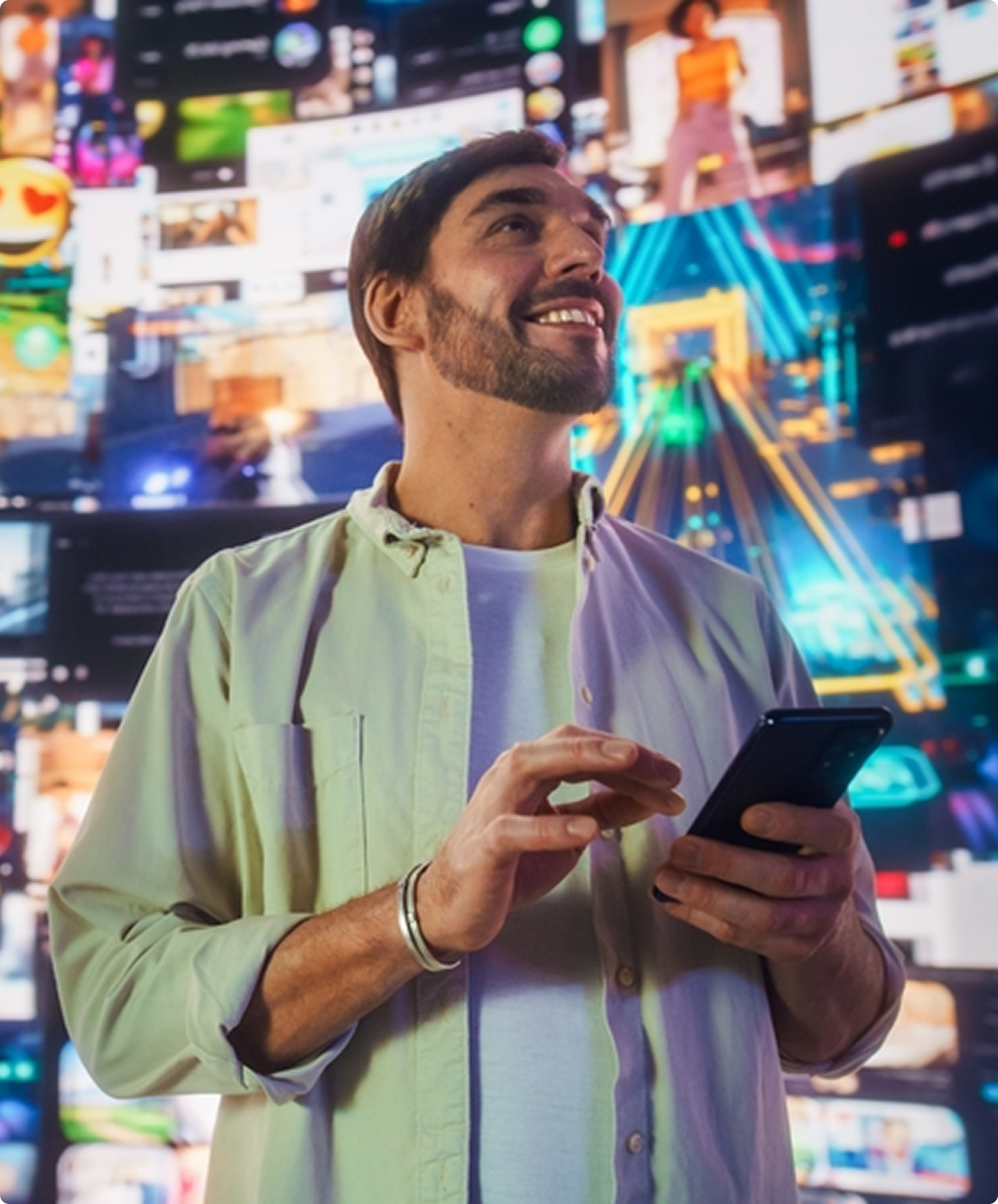 Man holding smartphone in front of digital screen wall