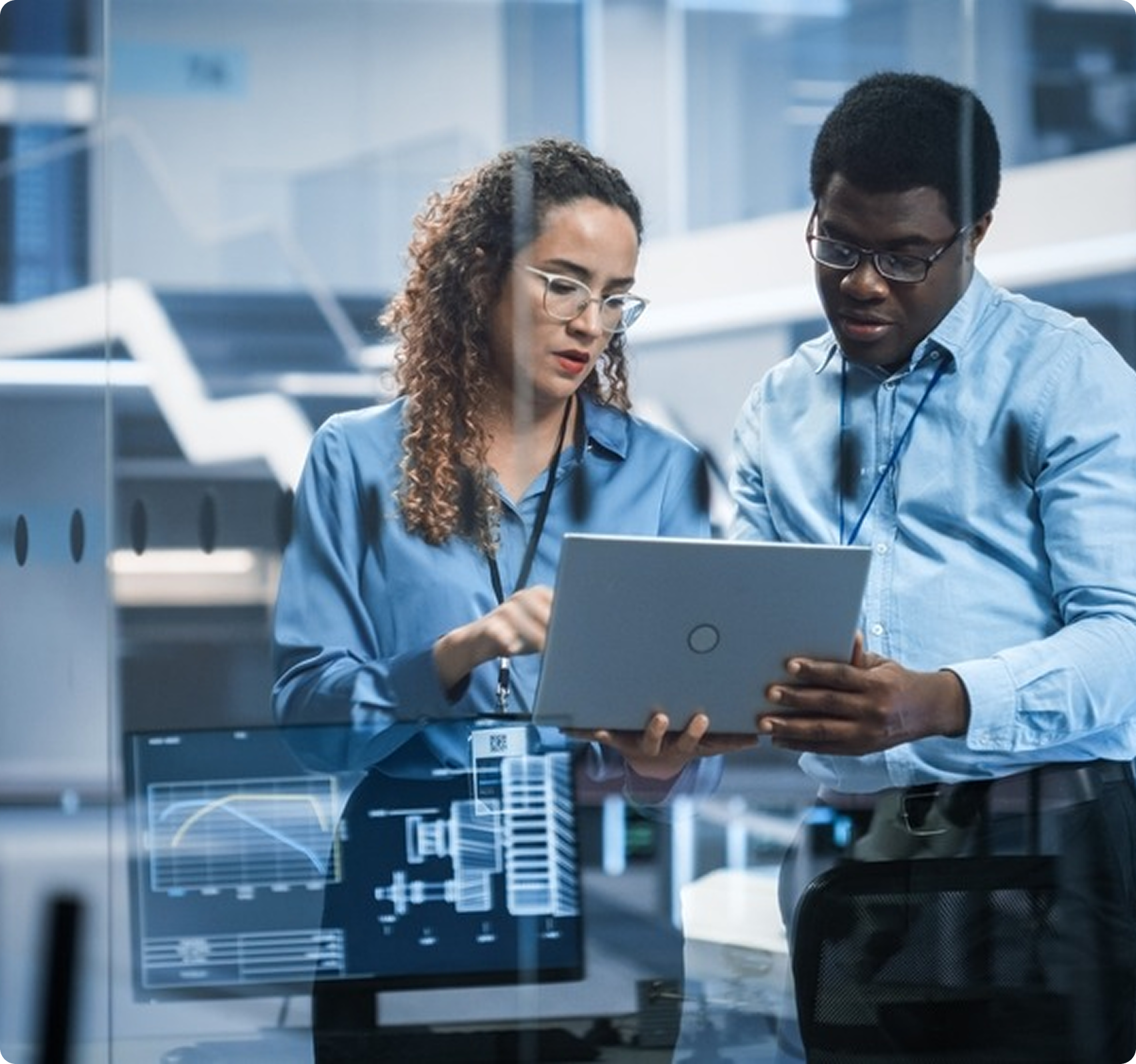 R&D team reviewing laptop analytics in modern office