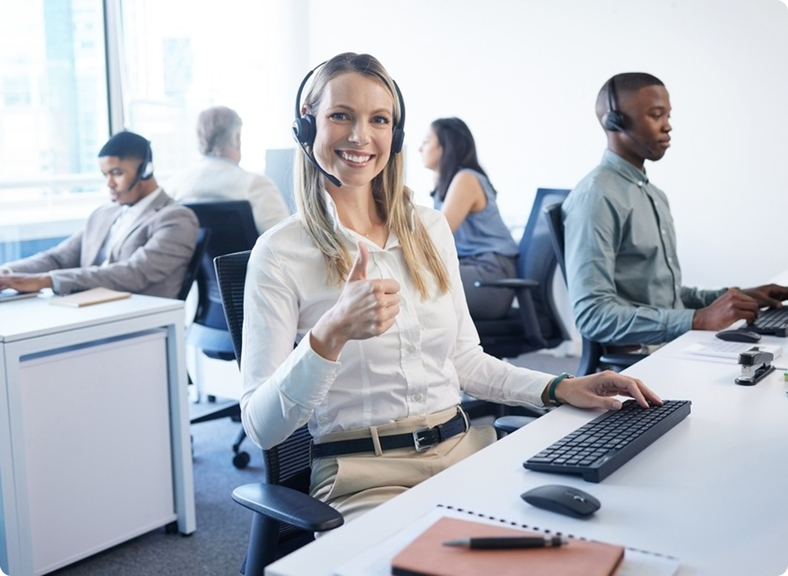 Call center office team working on desktop computers