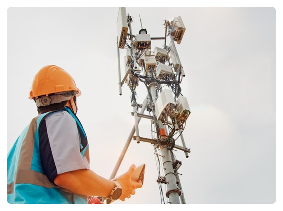 Telecom engineer inspecting cell tower equipment