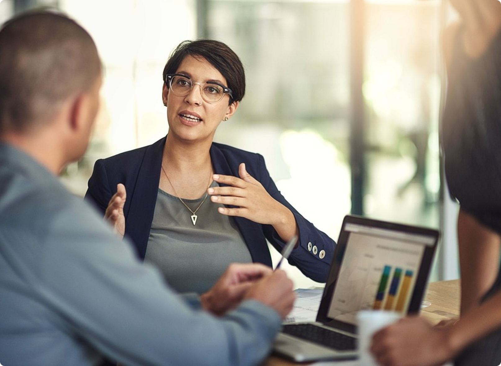Business executives discussing financial metrics in office