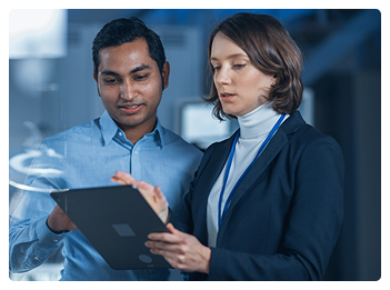 Engineers reviewing tablet data analytics and technical specifications